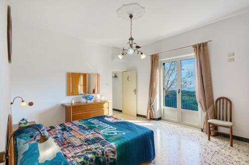 a bedroom with a bed and a dresser and a window at Bella veduta Sun in Agerola