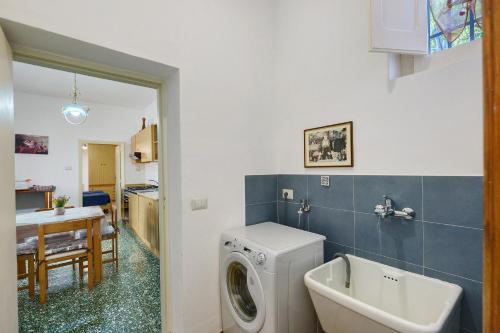 a bathroom with a washing machine and a sink at Bella veduta Sun in Agerola
