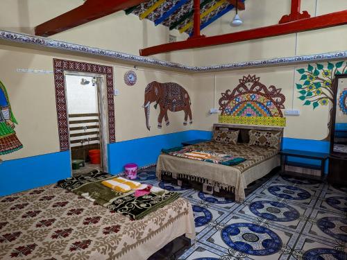 a room with two beds and a painting of a horse on the wall at White Land Village Stay in Dhordo