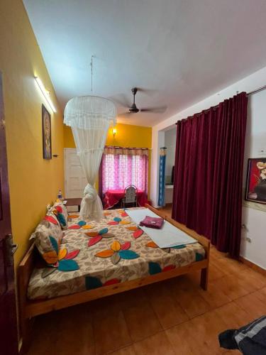 a bedroom with a bed with a comforter at iha ayurveda resort in Varkala