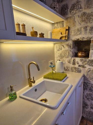 a white sink in a kitchen with a counter at Apartment Dyonis Perast in Perast