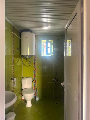 a bathroom with a toilet and a sink at E2 Residence in Balchik