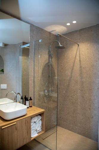 a bathroom with a shower and a sink at Uzeiri Guest Hotel in Borsh