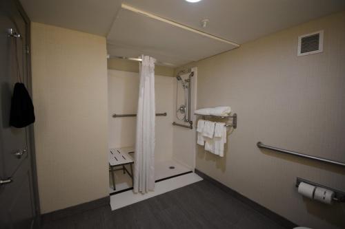 a bathroom with a shower with a shower curtain at Holiday Inn Hazlet by IHG in Hazlet