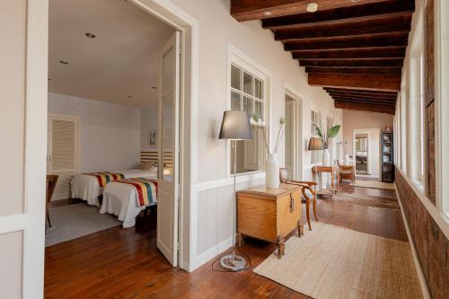 a bedroom with two beds and a table with a lamp at Orotava The Home - Vacational rental with the lifestyle of 1700 and the comfort of 2022 in La Orotava