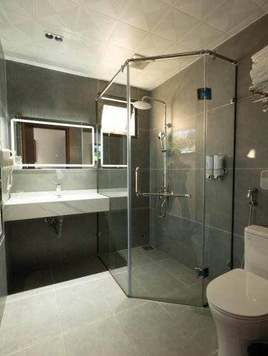 a bathroom with a shower and a sink and a toilet at Viet Phuong Center Hotel in Ninh Binh