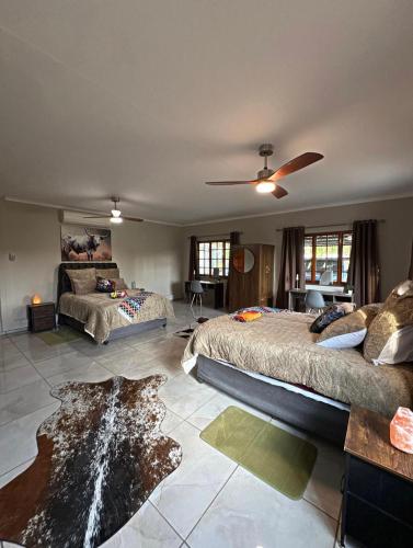 a large bedroom with two beds in a room at Nguni Gaste Huis in Mooinooi