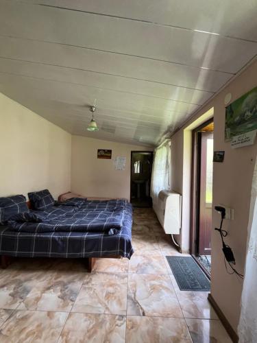 a bedroom with a bed in the middle of a room at Maia's Guest House Gergeti in Kazbegi