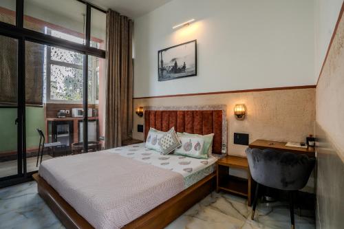 a hotel room with a bed and a desk and a desk at Le Fort Homestay in Jaipur