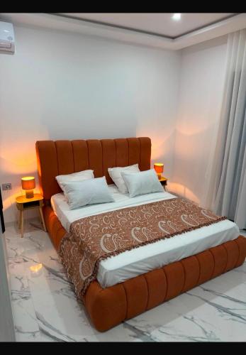a bedroom with a large bed with a large headboard at Villa Tanit in Taguermess