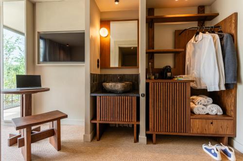 a bathroom with a sink and a wooden cabinet at chic&basic Tokyo Hoose in Porto