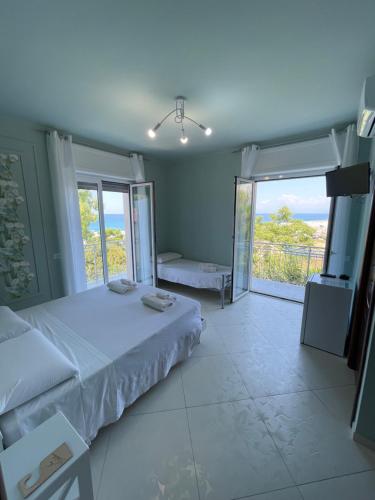a bedroom with a bed and a view of the ocean at B&B Riviera Azzurra in Cirella
