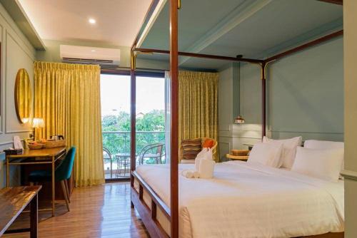 a bedroom with a large bed and a balcony at The Craft Nimman in Chiang Mai