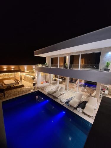 a house with a swimming pool at night at Vila Olive 51 in Tivat