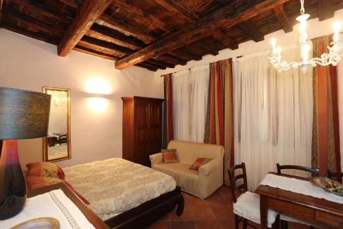 フィレンツェにあるAppartamento Pontevecchioのベッドルーム1室(ベッド2台、椅子、デスク付)