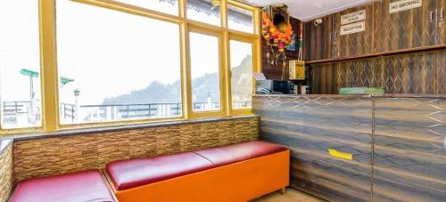 a restaurant with a bench in front of a counter at Sagar plaza in Mussoorie