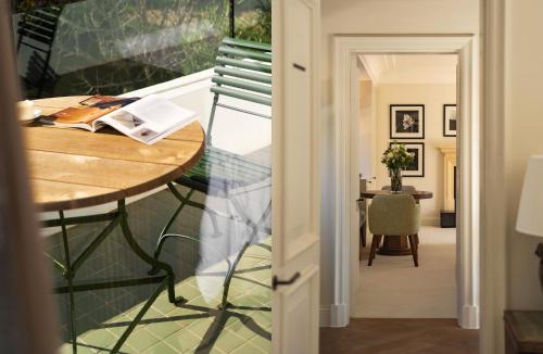 a hallway with a table and a dining room at Maison Cabrière Boutique Hotel in Franschhoek