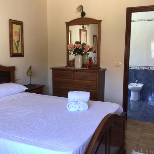 a bedroom with a bed and a mirror and a sink at HYP - Aranza Descanso Natural in Sotomayor