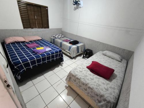 a room with two beds in a room at Recanto do trabalho in Brasília