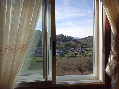 a window with a view of a mountain view at HYP - Aranza Descanso Natural in Sotomayor