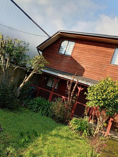 a brick house with windows on the side of it at Hostal y Cabañas Guaje in Valdivia