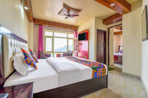 a bedroom with a large bed and a window at Sagar plaza in Mussoorie