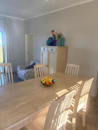a dining room table with a bowl of fruit on it at Katkop Resort in Graafwater