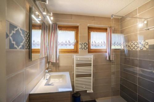a bathroom with a sink and a shower at Val Pierre in Châtel