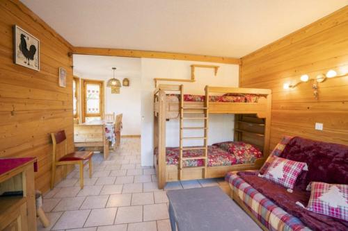 a room with two bunk beds and a couch at Val Pierre in Châtel