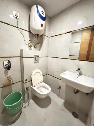 a bathroom with a toilet and a sink at Royal with - Group Name Hotel Double R- comfort stay in Main Bazar New Delhi in New Delhi