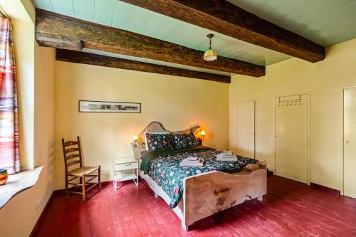 a bedroom with a bed and a table and a chair at Het Schultehuis in Anloo