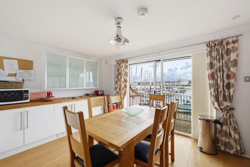 a kitchen and dining room with a table and chairs at Marina View in Plymouth