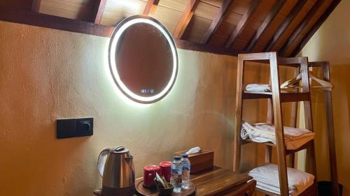 a bathroom with a mirror on a wall with a sink at The Grembeng in Undisan