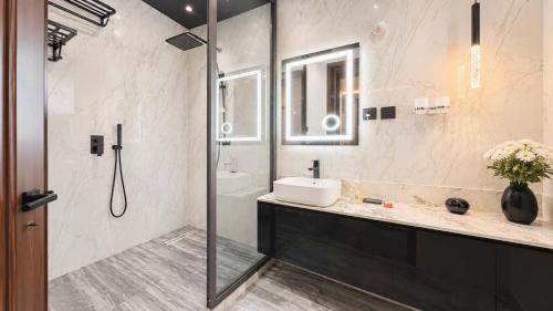 a bathroom with a shower and a sink and a sink at Richgates Apartments in Enugu