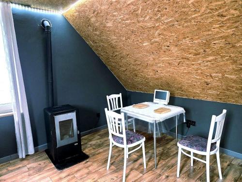 a table with two chairs and a laptop on it at Apartament Babina Loft in Żarkie Małe