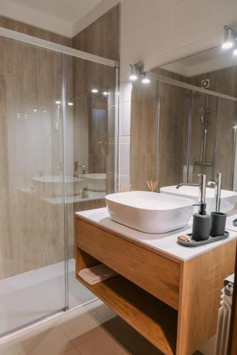 a bathroom with a sink and a shower at Casa do Suave Mar in Esposende