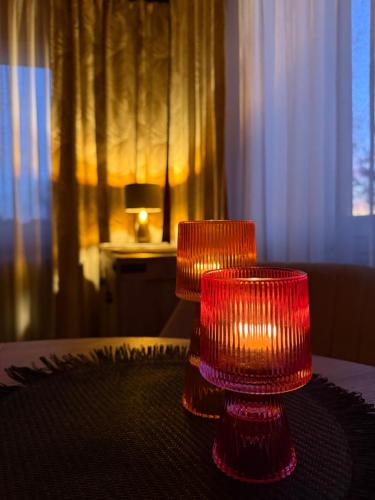 two red candles sitting on top of a table at Otuleni Kaszubami in Kiełpino