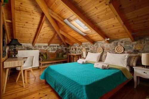 a bedroom with a bed and a wooden ceiling at Villa Galateia in Dhafnés