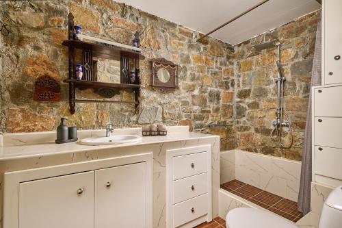 a bathroom with a sink and a shower at Villa Galateia in Dhafnés