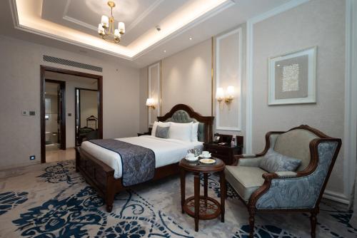 a hotel room with a bed and a chair at Hotel Express Inn Heritage Aurangabad Airport in Aurangabad