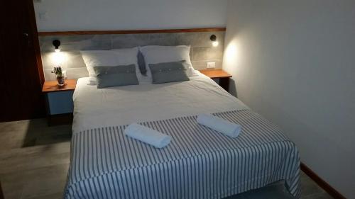 a bedroom with a large bed with two pillows at Hotel Stipe in Drage