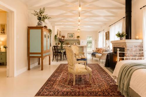 a bedroom with a bed and a living room at Constantia French Cottage in Sweet Valley