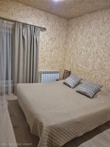 a bedroom with a bed with two pillows on it at Modern Apartment Near Sevan Lake in Sevan