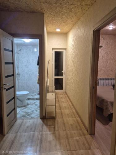 a room with a bathroom with a toilet and a door at Modern Apartment Near Sevan Lake in Sevan