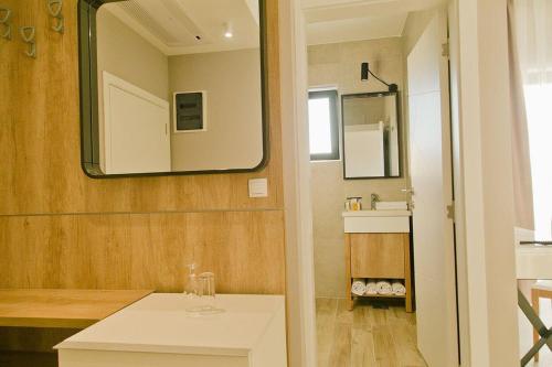 a bathroom with a sink and a mirror at Hotel Hills in Donji Štoj