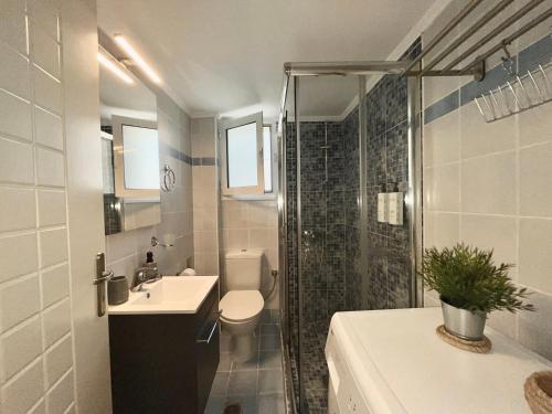 a bathroom with a toilet and a sink and a shower at Myrto2 apartment in Preveza