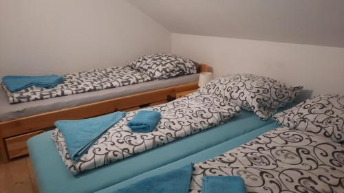 a room with two twin beds and a blue couch at Horský Apartmán Ramzová in Ramzová