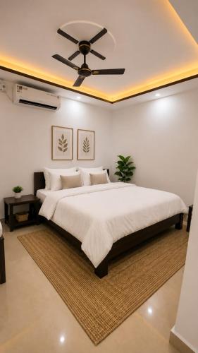 a bedroom with a large bed with a ceiling fan at Sevrina Beach Inn Calangute in Calangute