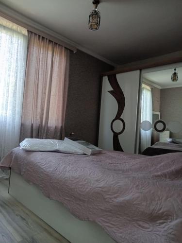 a bedroom with a bed and a large mirror at Chakvi hotel in Chakvi