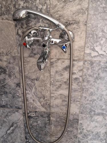 a shower head on a wall in a bathroom at Mountain Vista Resort in Roústika